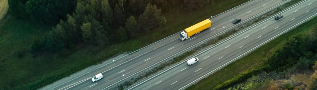 Aerial shot of a truck driving on the motorway