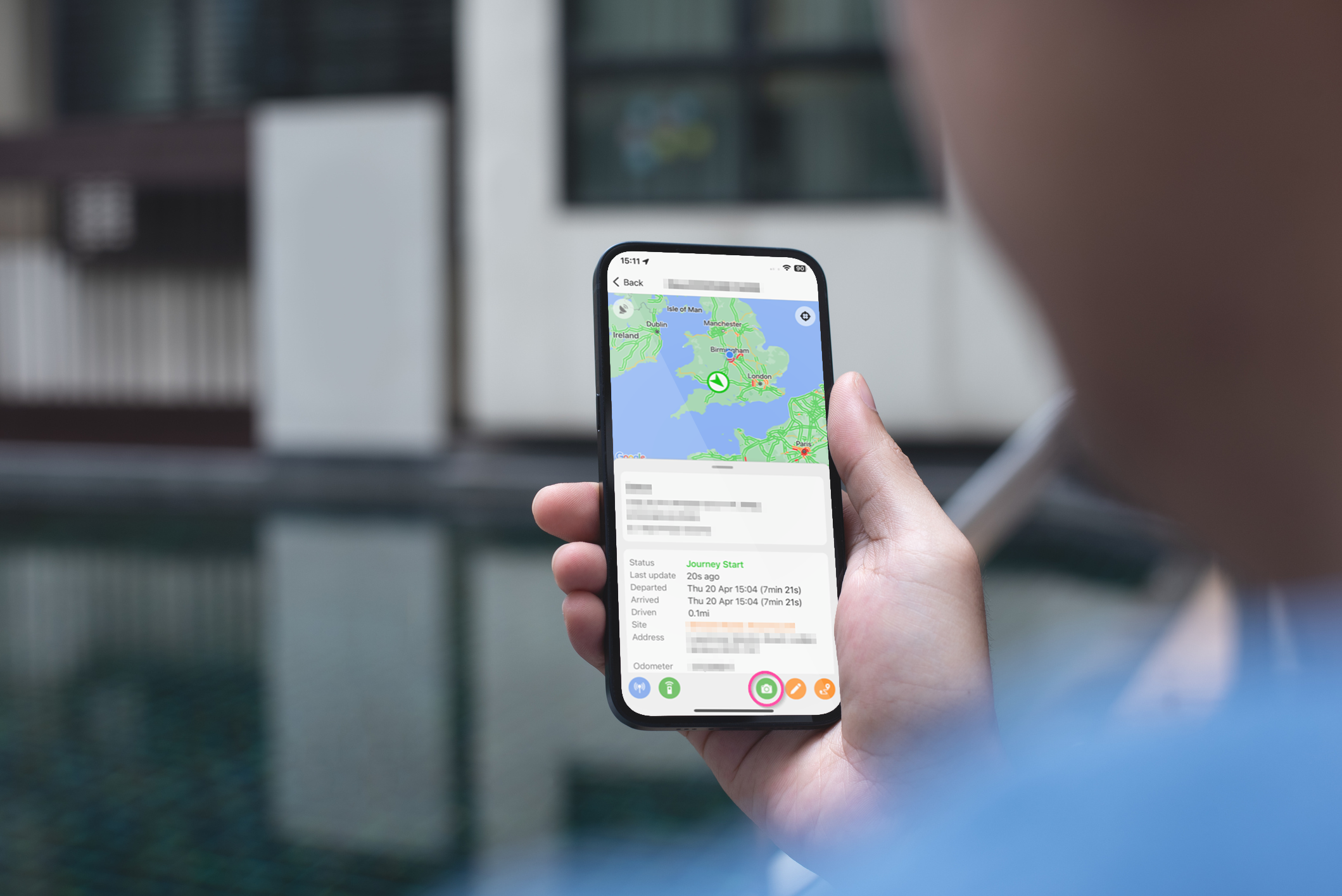 Man holding a mobile phone using the Fleet Witness App