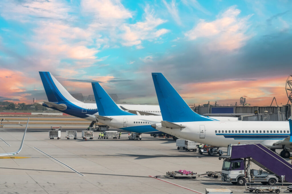 Airplane tail view at sunset at the airport.