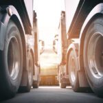 Two Semi Trucks a Parking at The Warehouse with Sunset Sky Industry Cargo Freight Truck Transportation - Fleet Witness - Fleet Tracking Two Semi Trucks a Parking at The Warehouse with Sunset Sky Industry Cargo Freight Truck Transportation