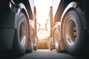 Two Semi Trucks a Parking at The Warehouse with Sunset Sky Industry Cargo Freight Truck Transportation