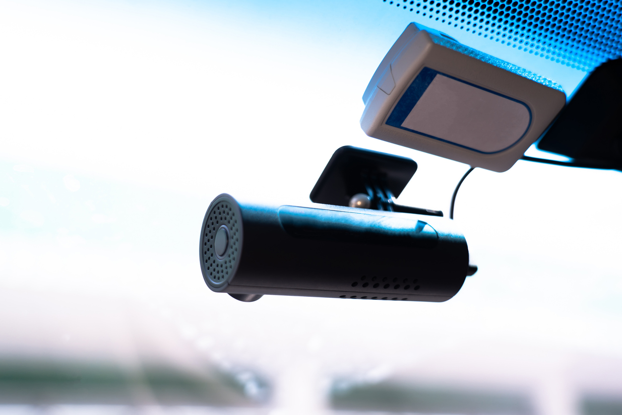 A small video camera records events. Attached to the windshield. Video monitoring concept for human driving safety