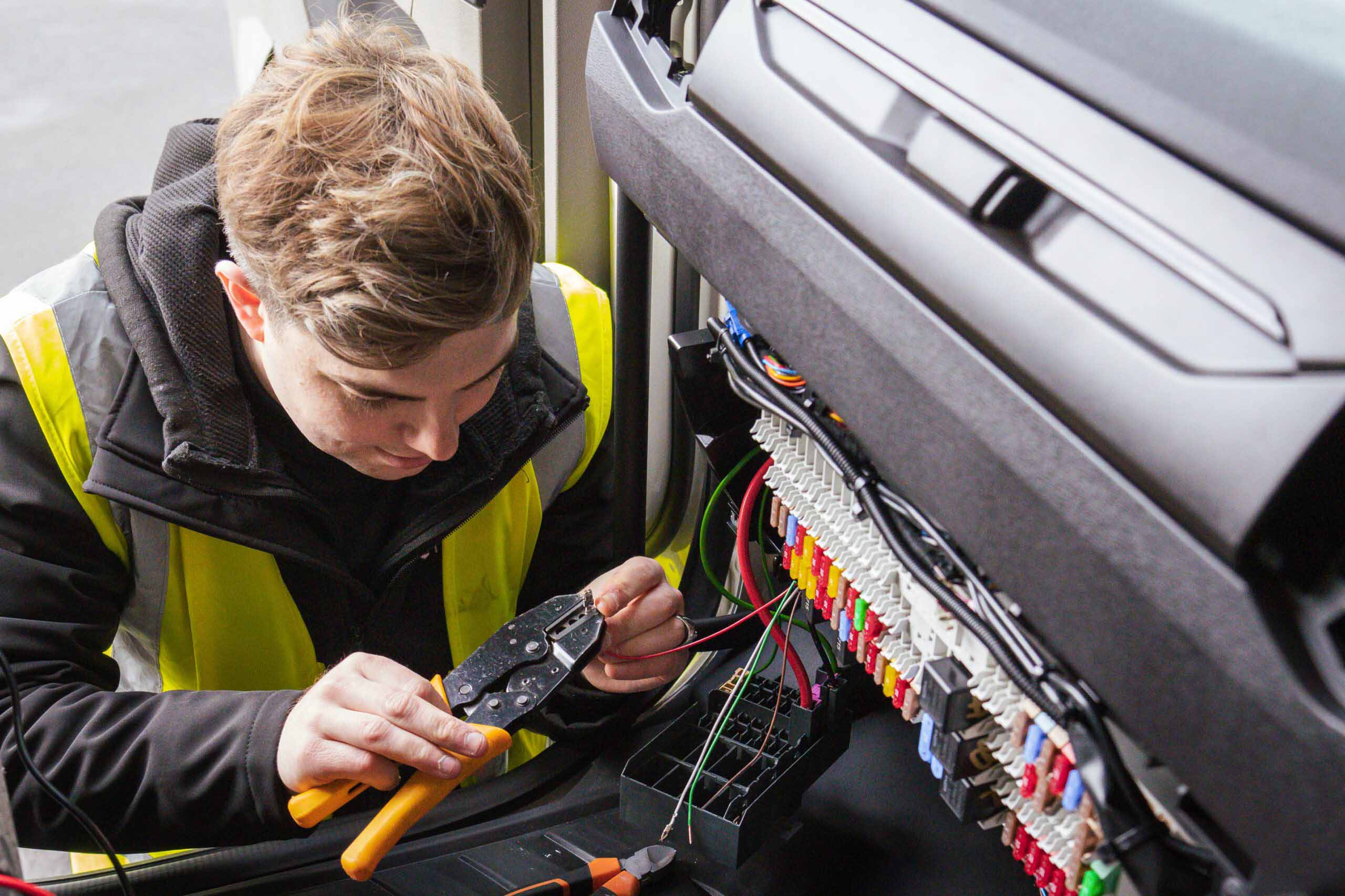 Engineer performing an installation in a vehicle