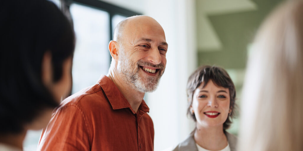 Professional Office Team Collaborating and Smiling in Bright Interior Space