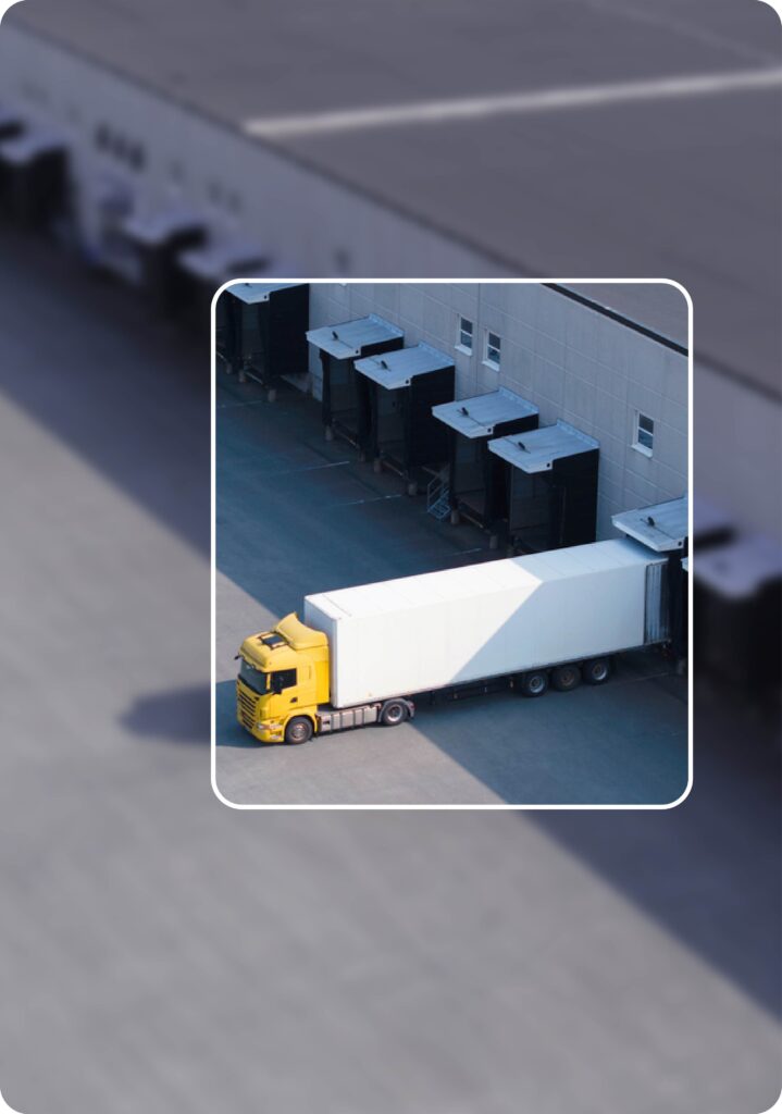 Trucks being loaded and unloaded at a warehouse.