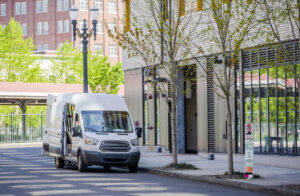 Compact commercial transportation economical, convenient minivan for small business or local moving and delivery of goods loading cargo from multilevels building in the city down town