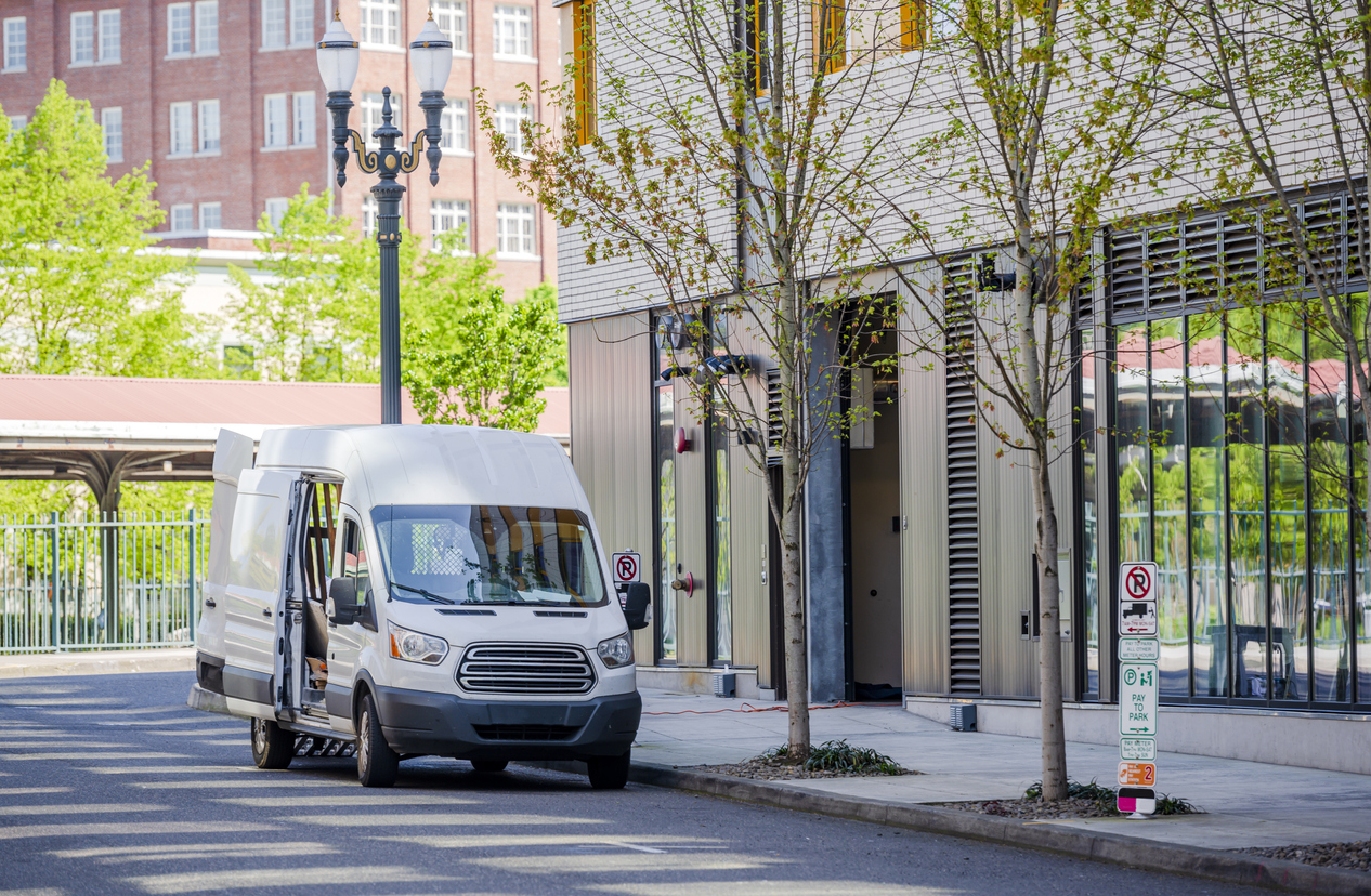 Compact commercial transportation economical, convenient minivan for small business or local moving and delivery of goods loading cargo from multilevels building in the city down town