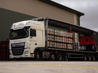 LWC Truck being unloaded with kegs via a forklift.
