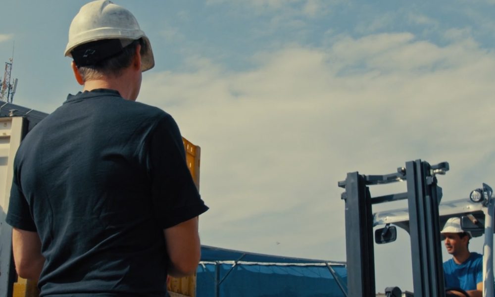 Logistics manager and forklift driver in the image